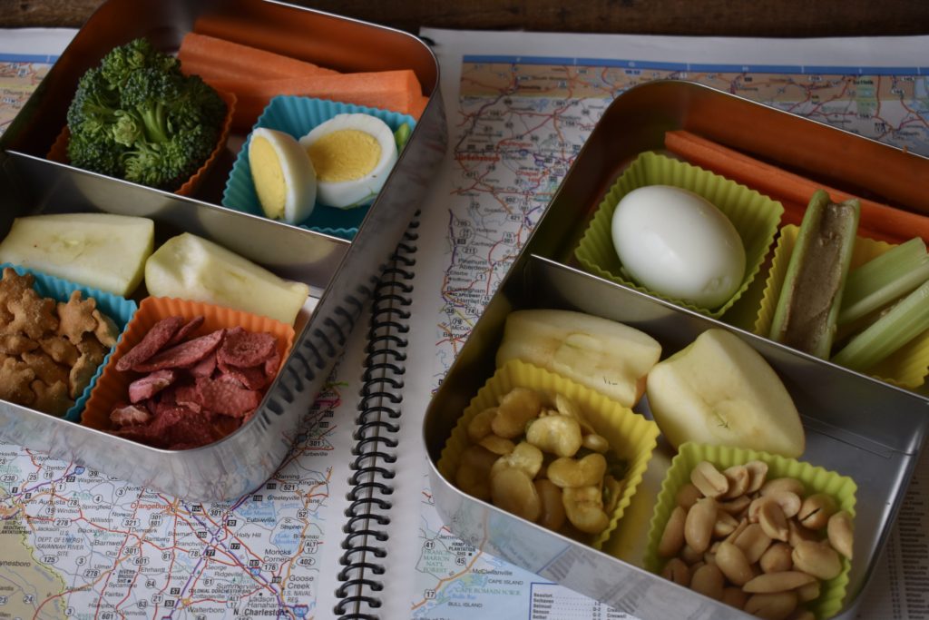 Nutritious Snacks for Travel. Two lunchbot containers with a variety of snacks in them.