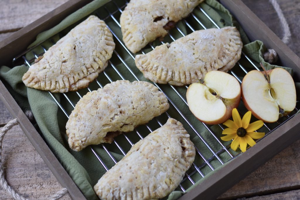 Grain free apple hand pies on a cooling rack.