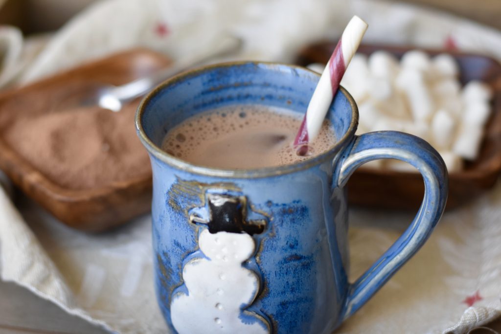 Naturally Sweet Homemade Hot Cocoa.  A cup of hot cocoa with a peppermint stick.