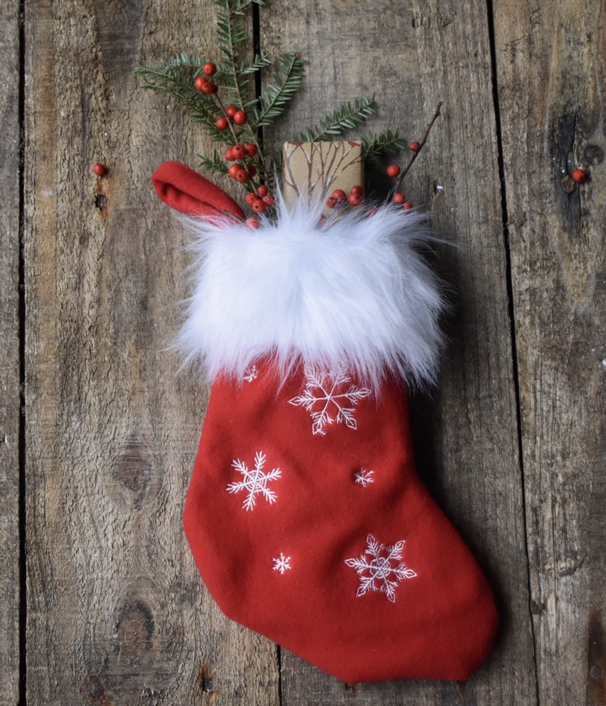 2019 Healthy Living Stocking Stuffer Ideas.  A red stocking with small gifts sticking out.
