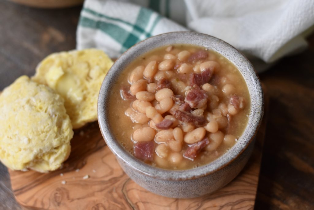 Classic Bean and Ham Soup in a dish with a grain free roll.