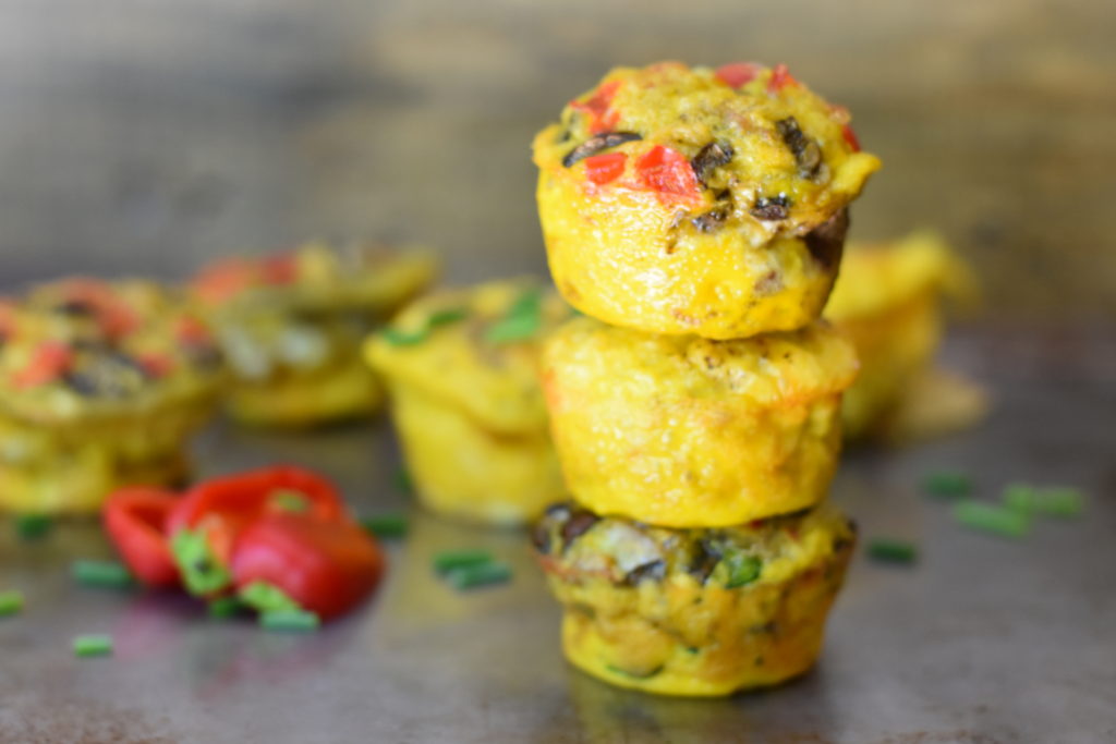 Omelet Breakfast Muffins stacked on a table.