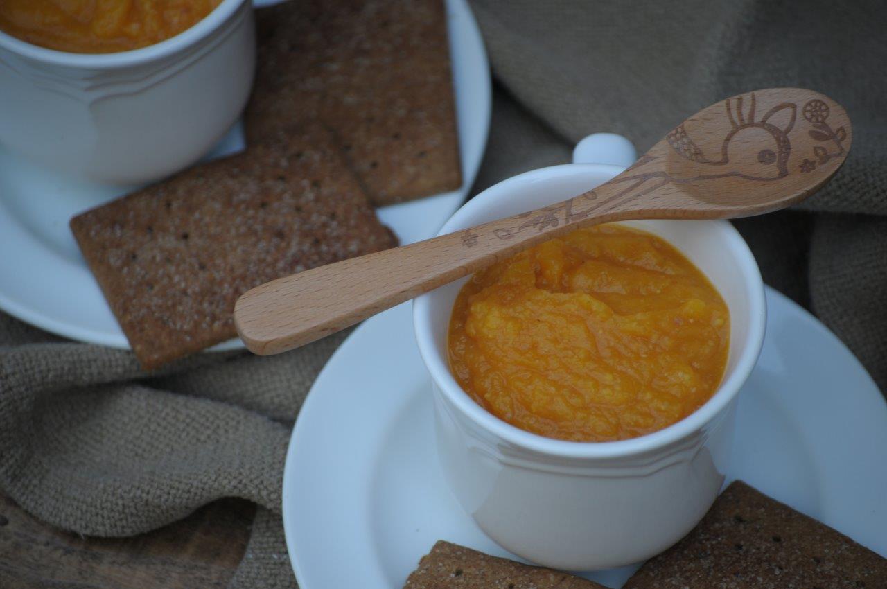 Nutritious Breakfast Ideas for Busy People. A cup of butternut squash soup with a wooden spoon.