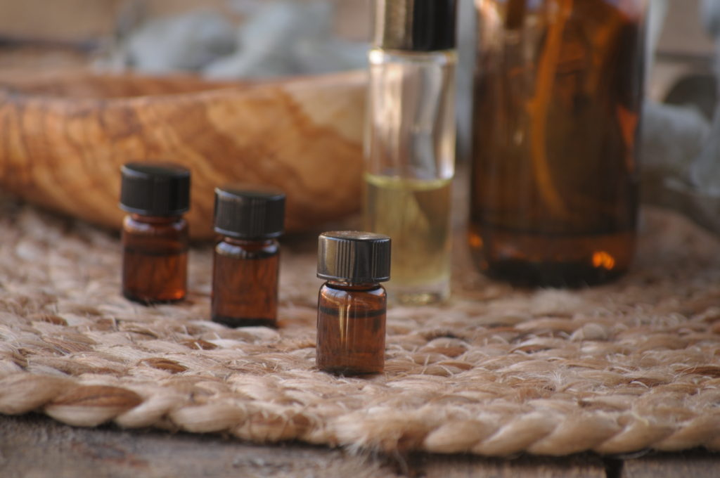 Powerful Essential Oils for Everyday Use - Part I. Small essential oil bottles on a woven mat.