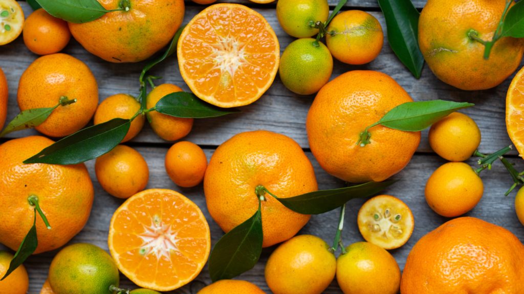 Essential oils for Everyday - Part II. Oranges of various sizes on a table.