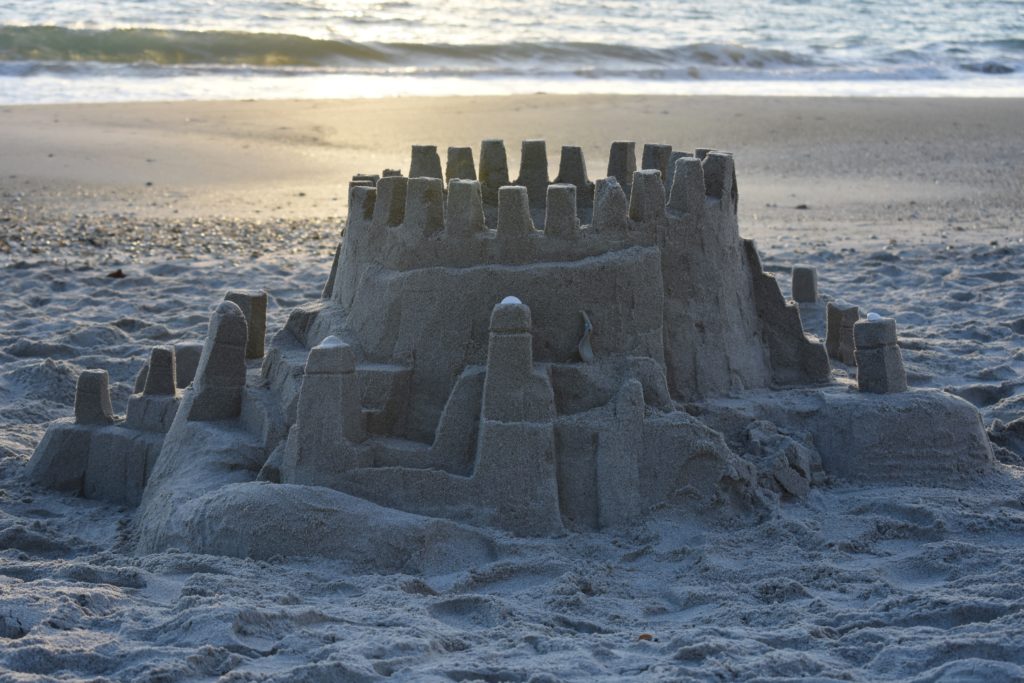 Visit the Beach for your health. A sandcastle on the beach.