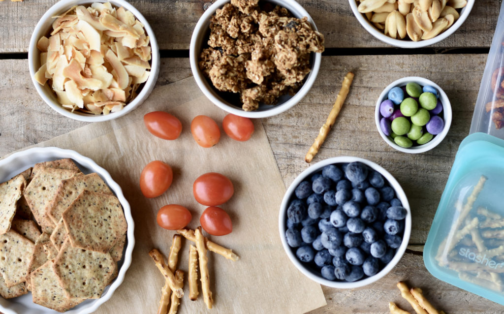 Nutritious Snacks for Travel include blueberries, granola and grain free crackers.