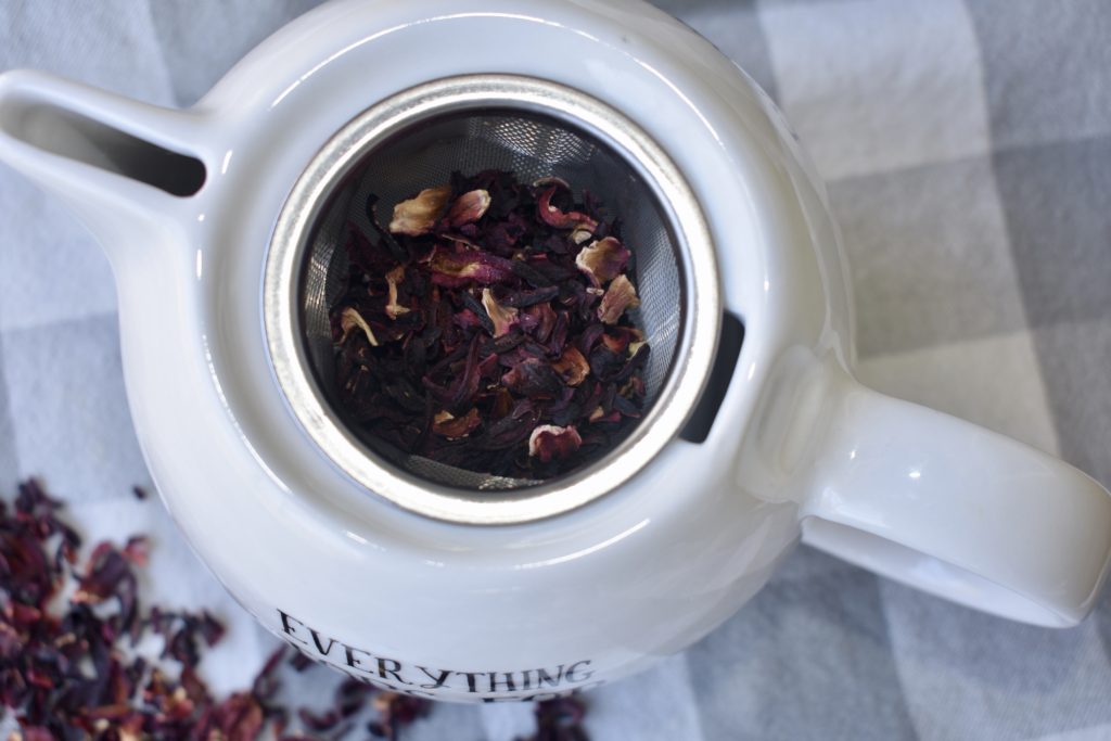 Health Benefits of Hibiscus Tea.  Hibiscus tea in a tea kettle.