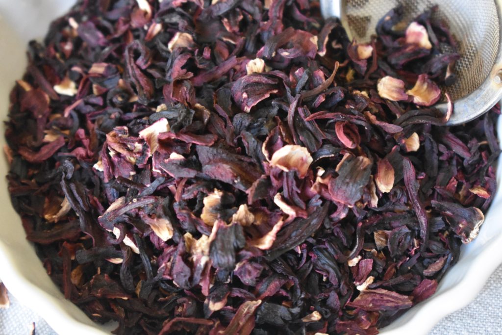 Health Benefits of Hibiscus Tea.  Dried tea in a dish.