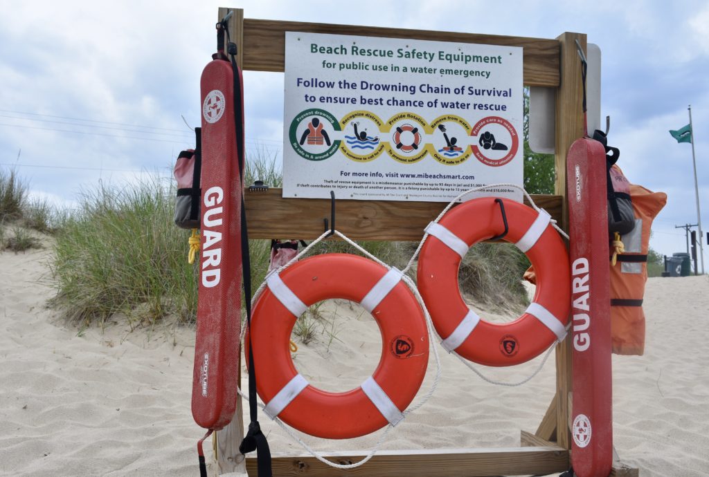 Explore Michigan Lighthouses and Sand Dunes. Safety Equipment stand by Lake Michigan.