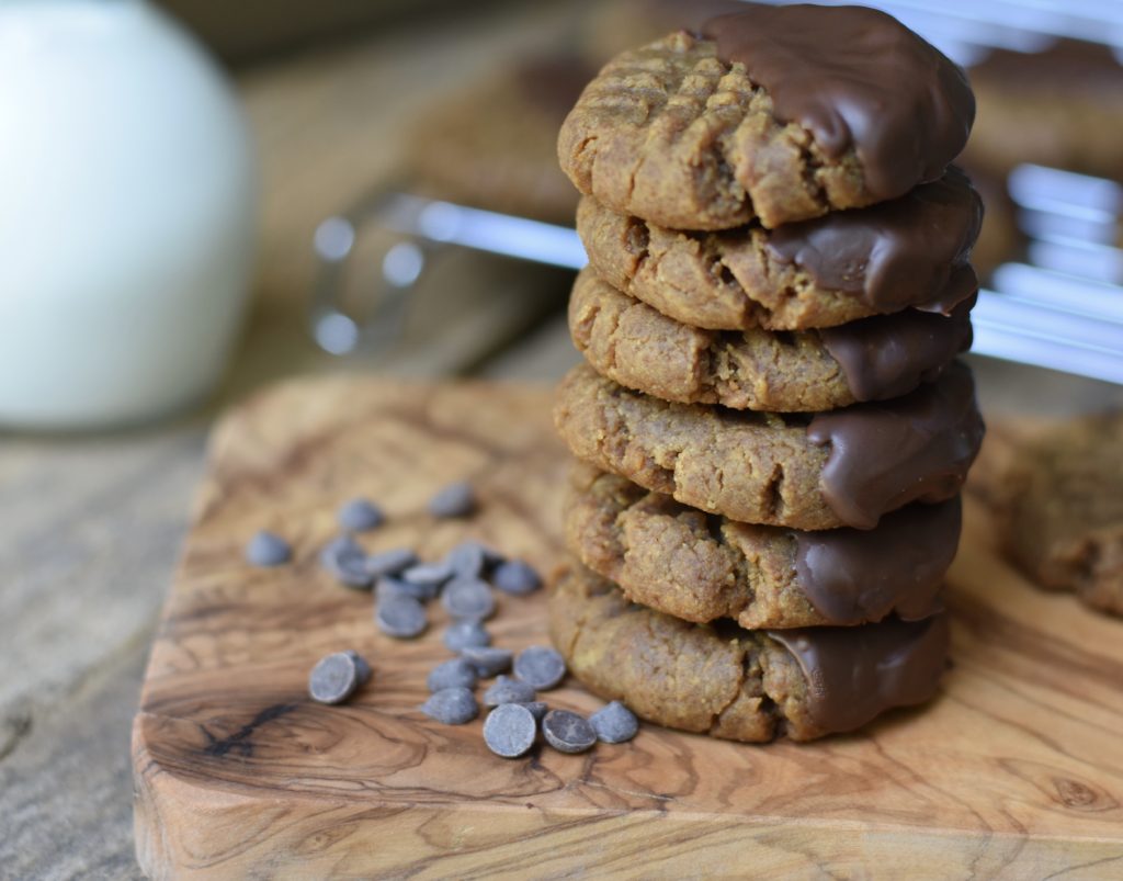 Grain Free Peanut Butter Cookies stacked on a cutting board.