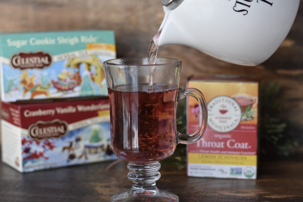 Natural Living Stocking Stuffer Gift ideas with a holiday tea being poured into a clear glass mug.