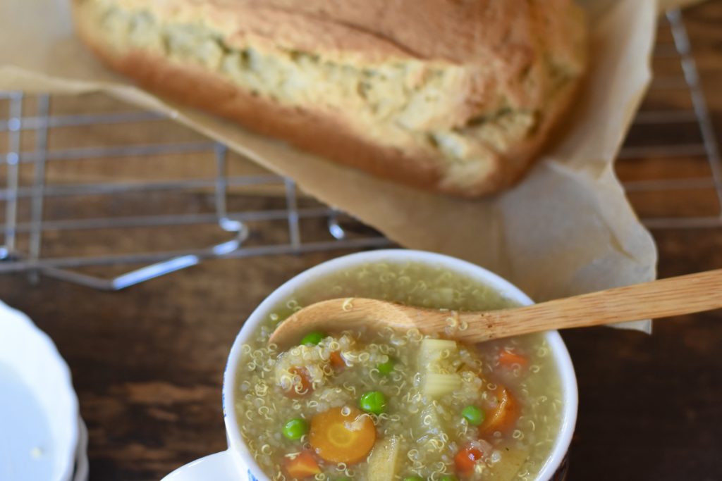 Vegetable Broth and Vegetable Quinoa Soup.  Vegetable soup in a bowl with a loaf of bread.