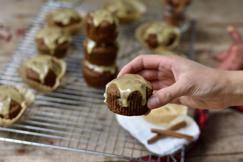 A person holding a grain free gingerbread muffin.