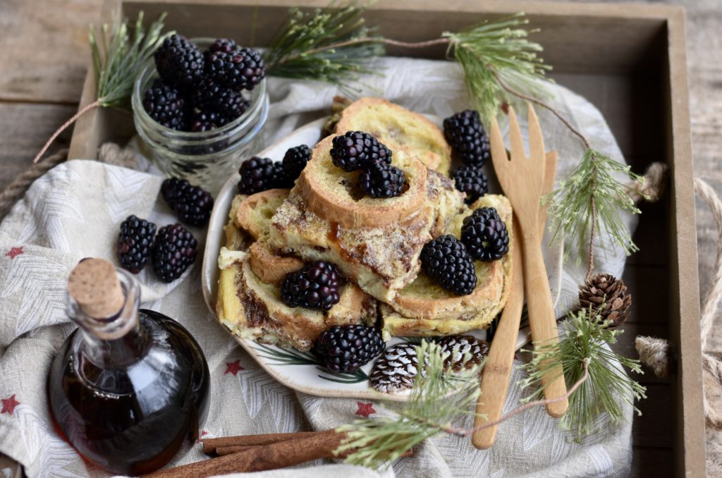 Cinnamon Baked French Toast served on a plate with blackberries.