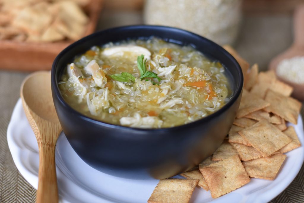 Chicken and Quinoa Soup in a bowl with grain free crackers.