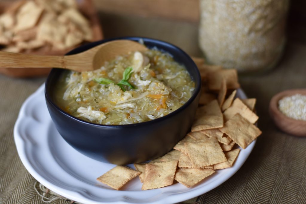 Chicken and Quinoa Soup in a dish with grain free crackers.