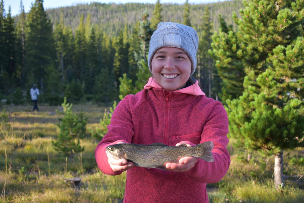 Get Outdoors to Boost Your Health. Girls holding a large rainbow trout.