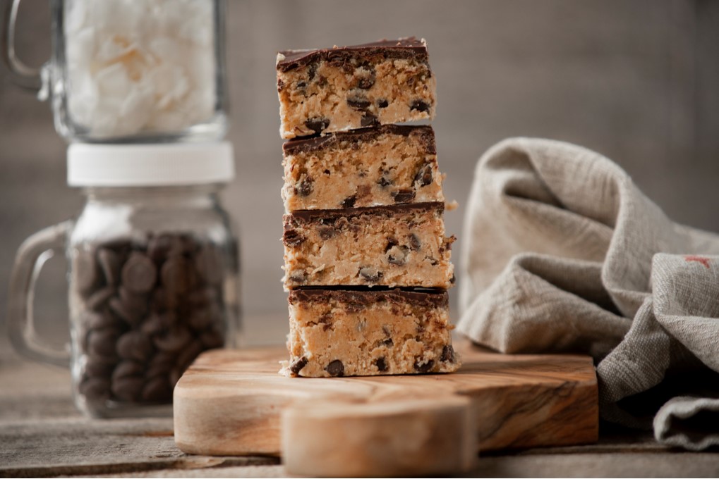 Chocolate Chip Cookie Dough Bars Grain Free stacked on a little board.
