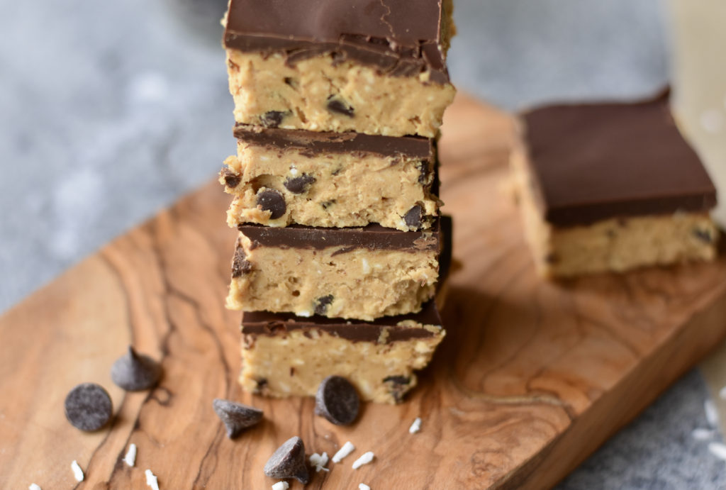 A stack of four chocolate chip cookie dough bars.