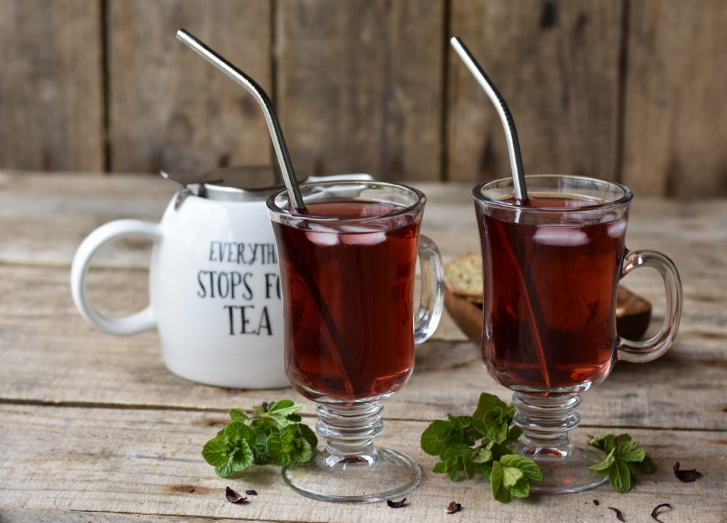 Health Benefits of Hibiscus Tea with two cups of tea.