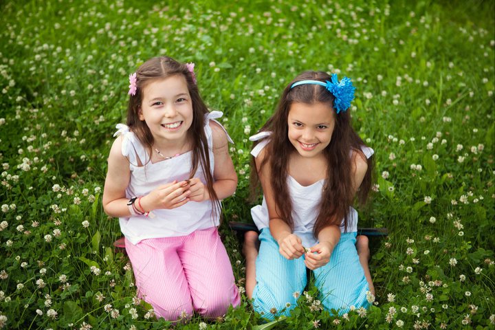 Build Our Kids Immunity with two girls sitting in the grass.