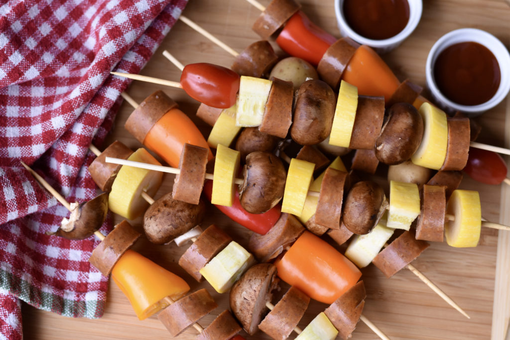 simple sausage and veggie kabobs on a cutting board.