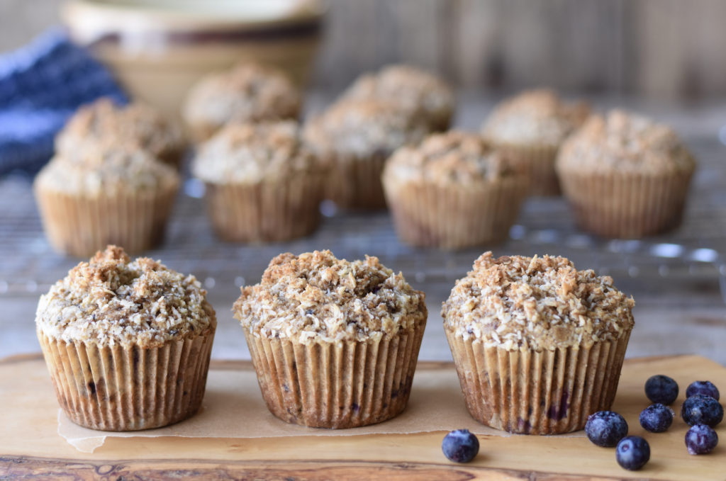 Grain free blueberry collagen muffins sitting on a board.