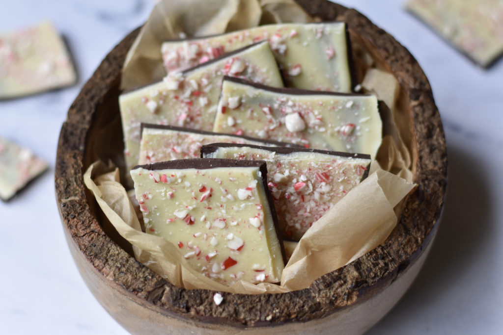 Gluten free white peppermint chocolate bark in a wooden bowl.
