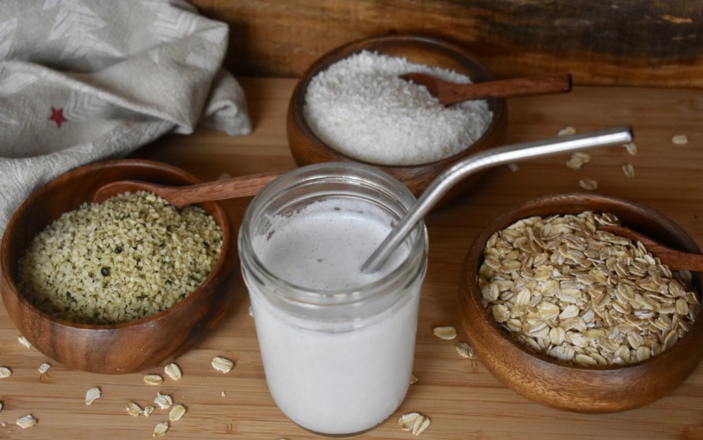 Dairy free milk options plus recipes. Hemp seeds, coconut and oats shown beside a glass of milk.