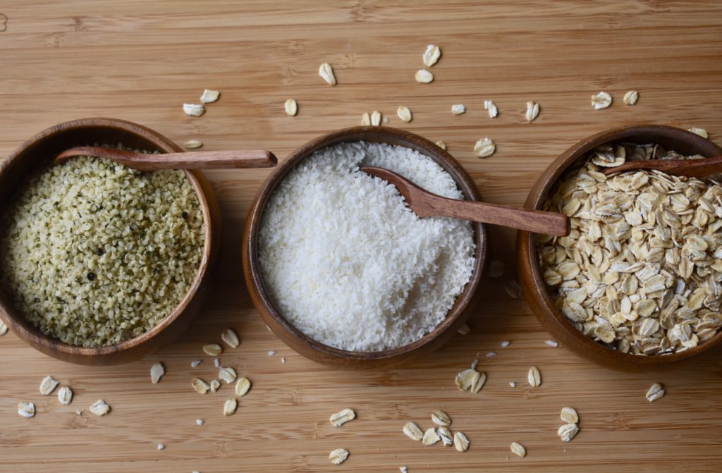 Dairy Free milk options plus recipes.  Hemp seeds, coconut milk and oats in wooden bowls.
