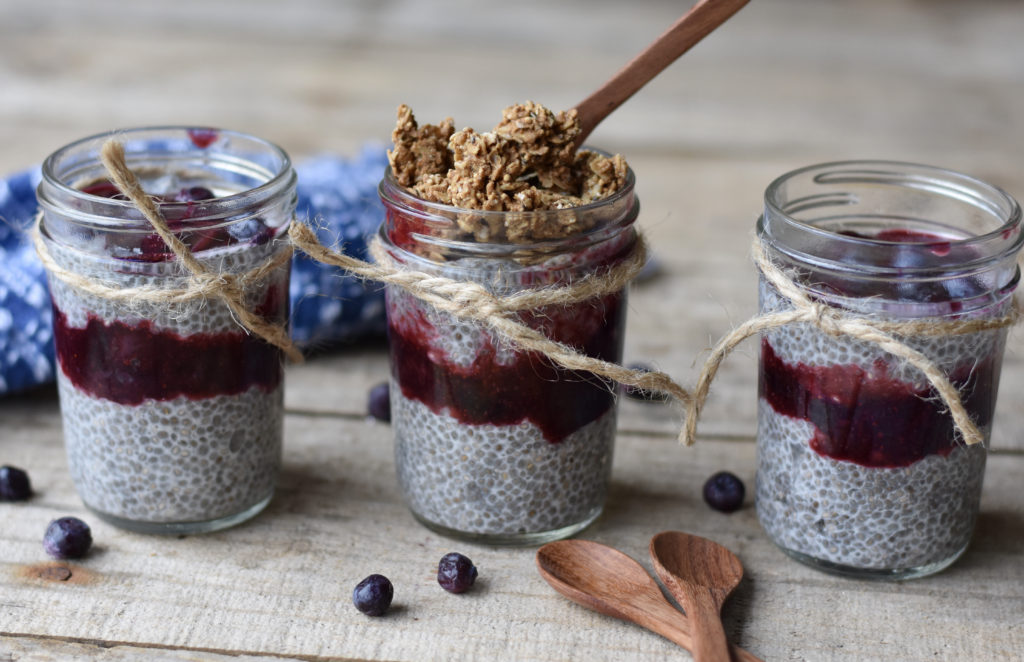 Blueberry Vanilla Chia Pudding in three glass canning jars.