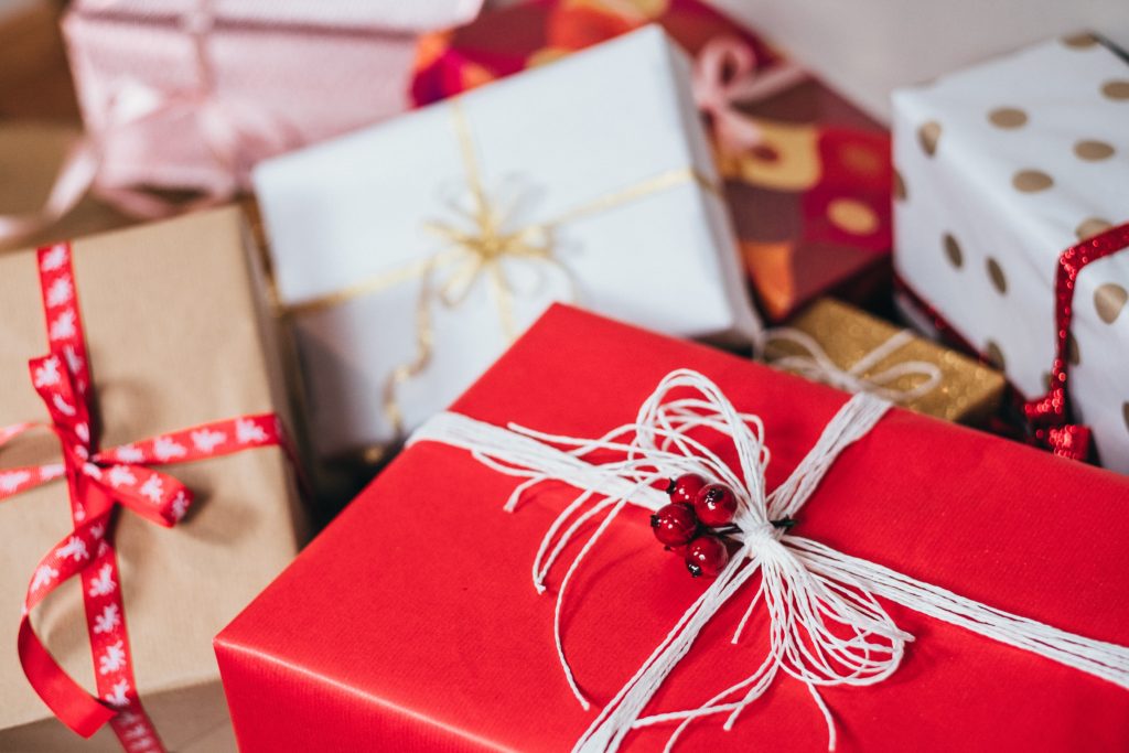 Healthy Lifestyle Holiday Gift Guide with a stack of wrapped presents.