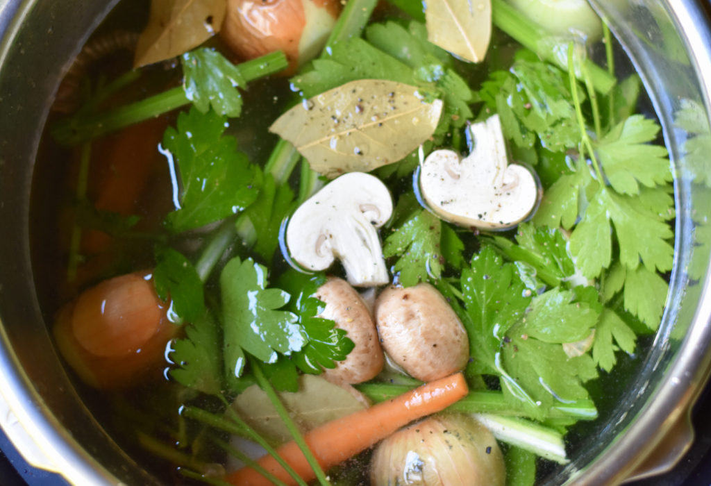 Vegetables in a stainless steel pot and ready to make vegetable broth n the Instant Pot.