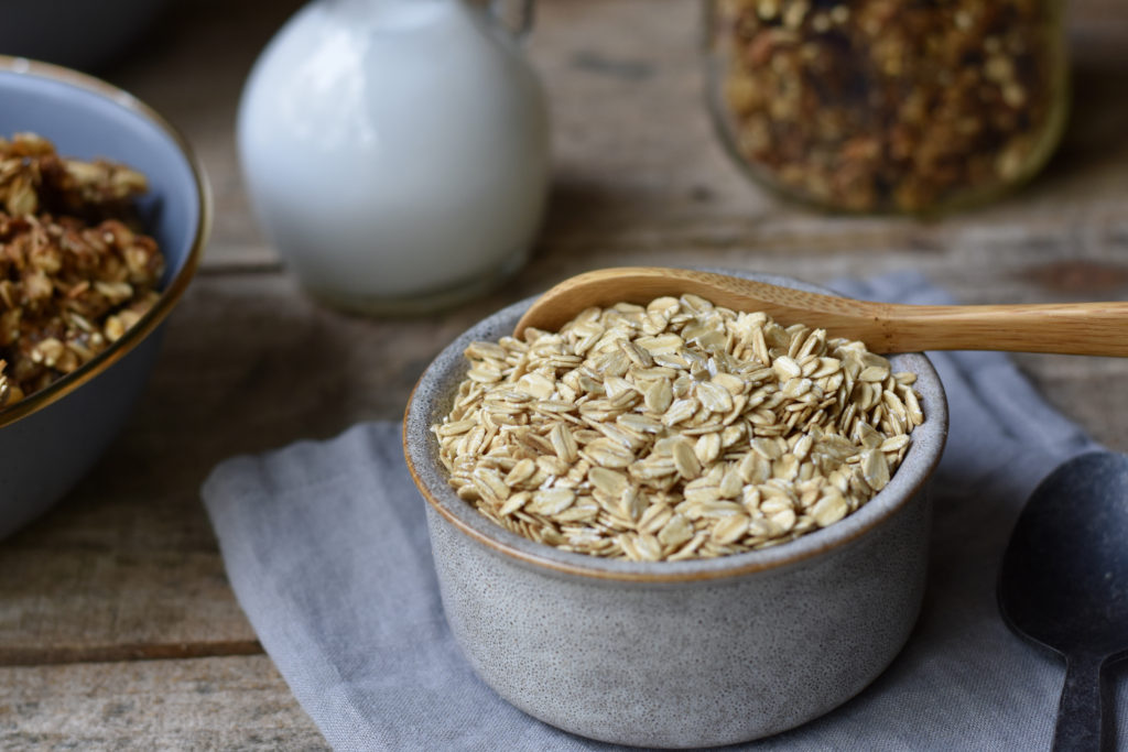 Nutritious Breakfast Ideas for Busy People with a bowl of oats in the front and a partially shown bowl with granola in it.