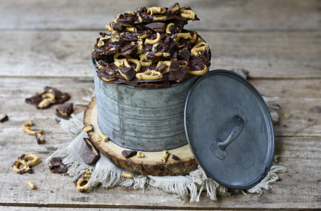 A tin bucket with peanut butter chocolate pretzel bark.