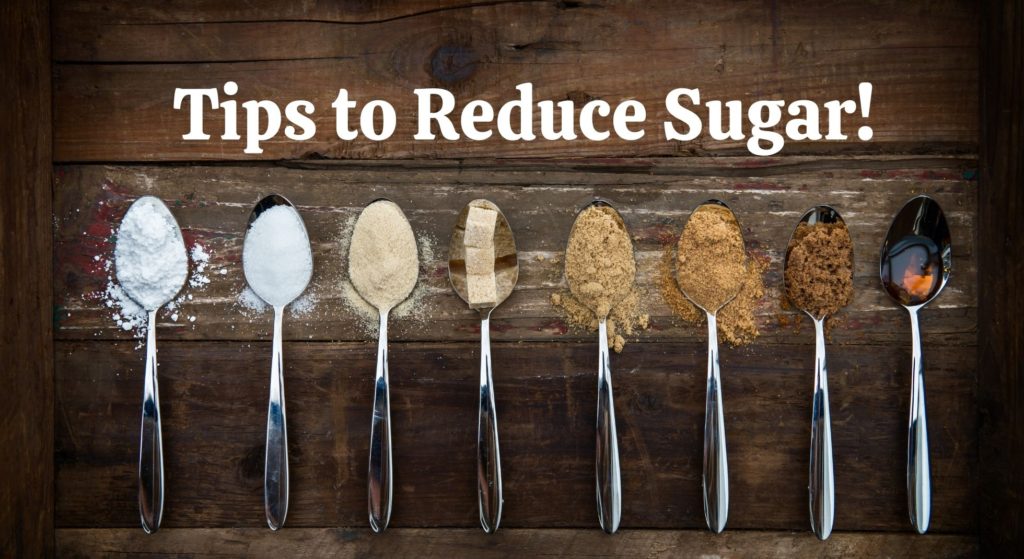Eight silver spoons with different types of sugar on them.  Caption reading Tips to Reduce Sugar.