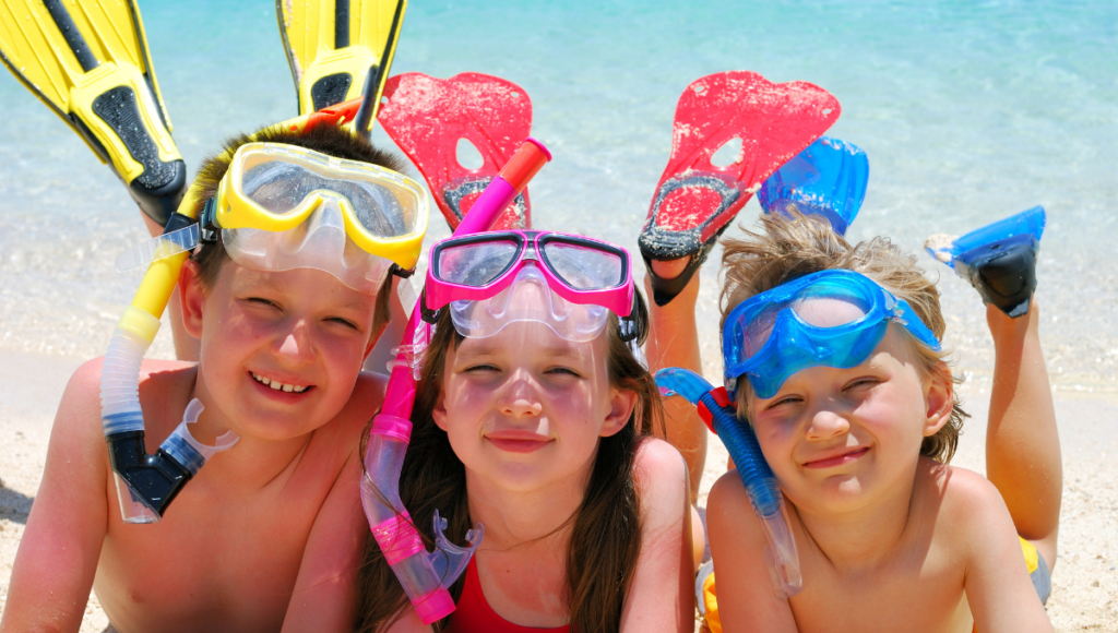 Healthy Outdoor Warm Weather Activities with kids on a beach with snorkel gear.