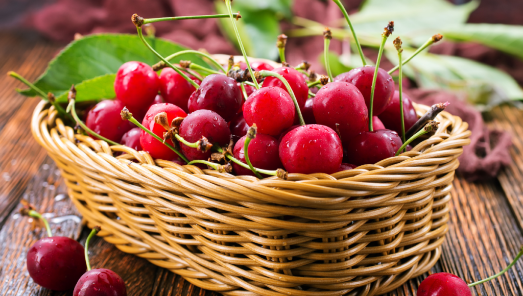 Improve your health with nutritious berries.  A basket full of bright red cherries with stems.