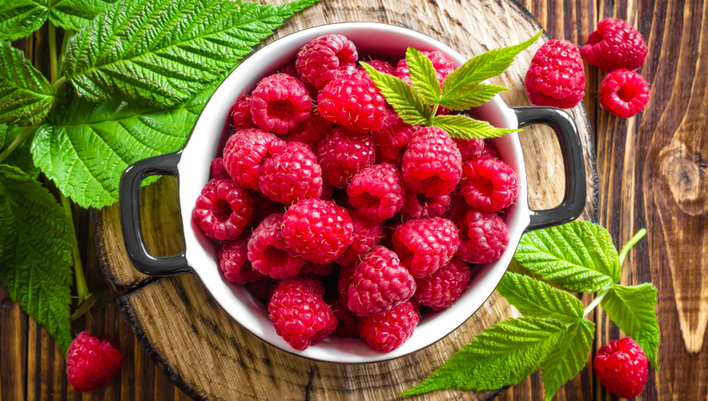 Improve your health with nutritious berries.  A white bowl full of raspberries.