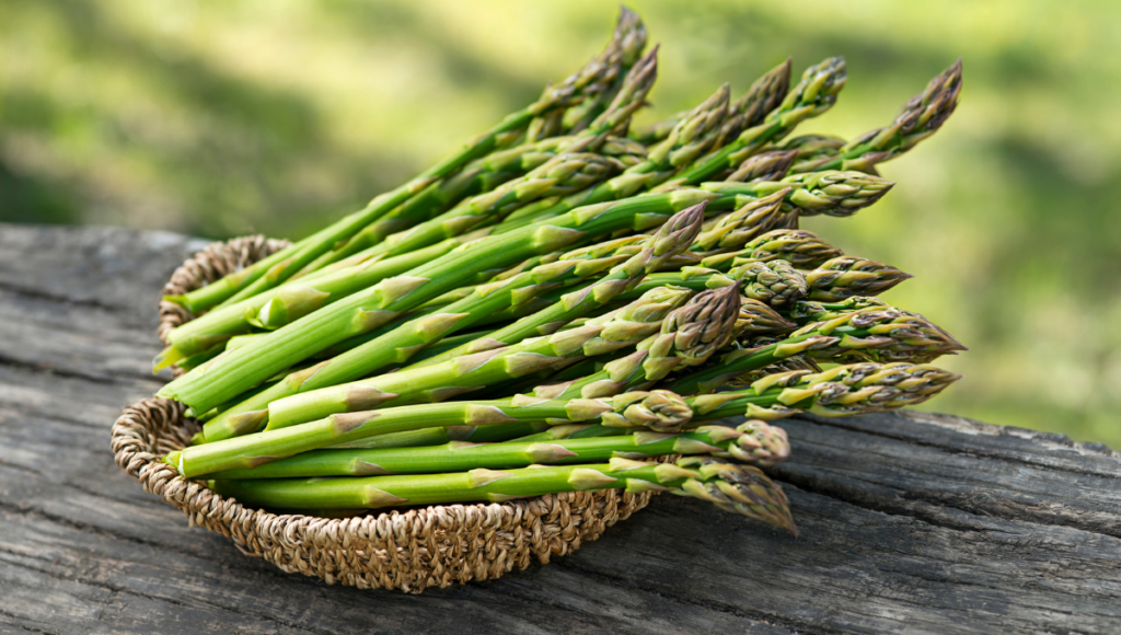 A large bunch of asparagus in a basket.