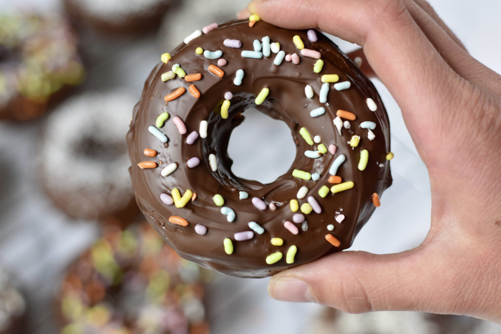 Grain free cake doughnuts with one doughnut with sprinkles.