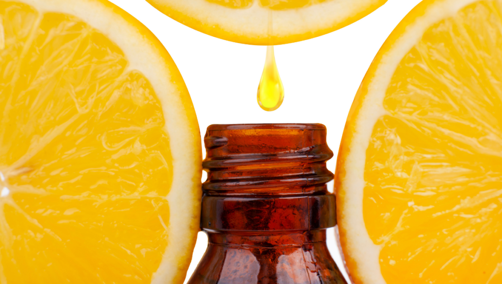Benefits of Lemon essential oil with lemon drop going into an amber bottle.