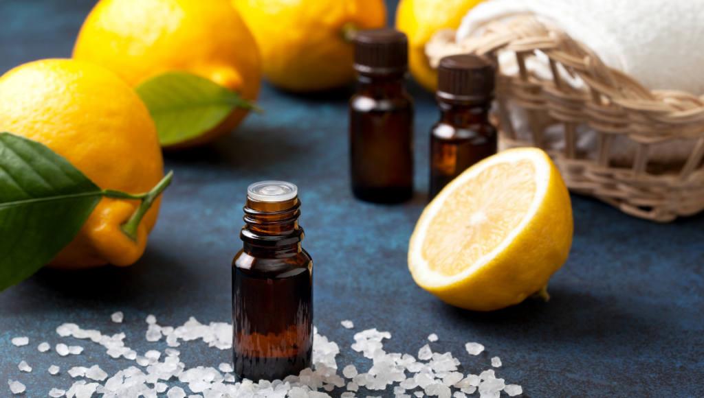 Benefits of using lemon oil with lemons and an amber bottle shown.